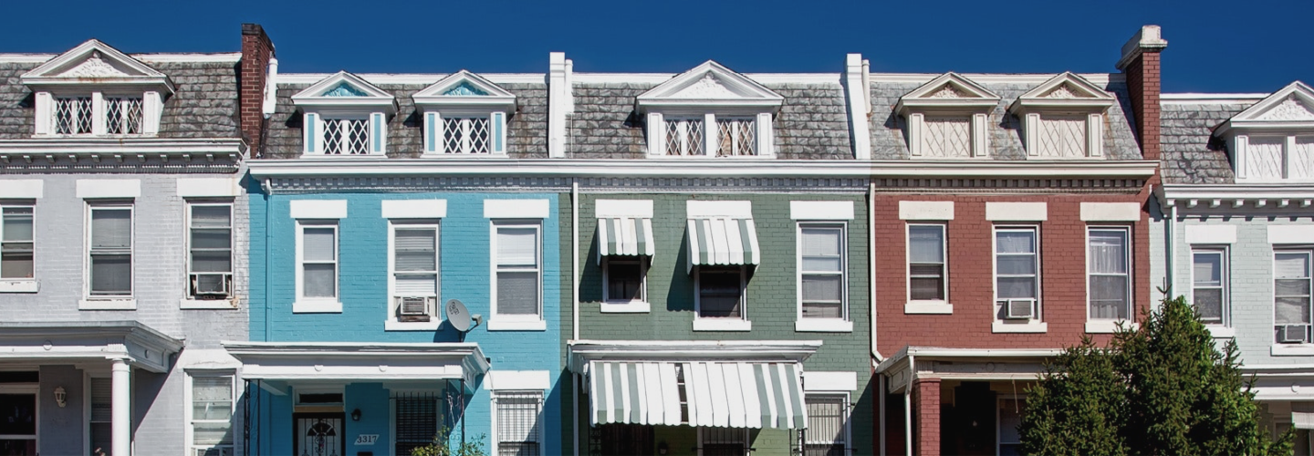 A row of townhouses all different colors.
